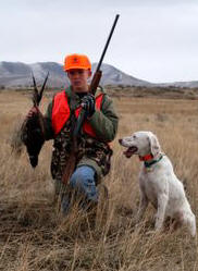 Hunter with bird and dog. Photo by Harry Morse.