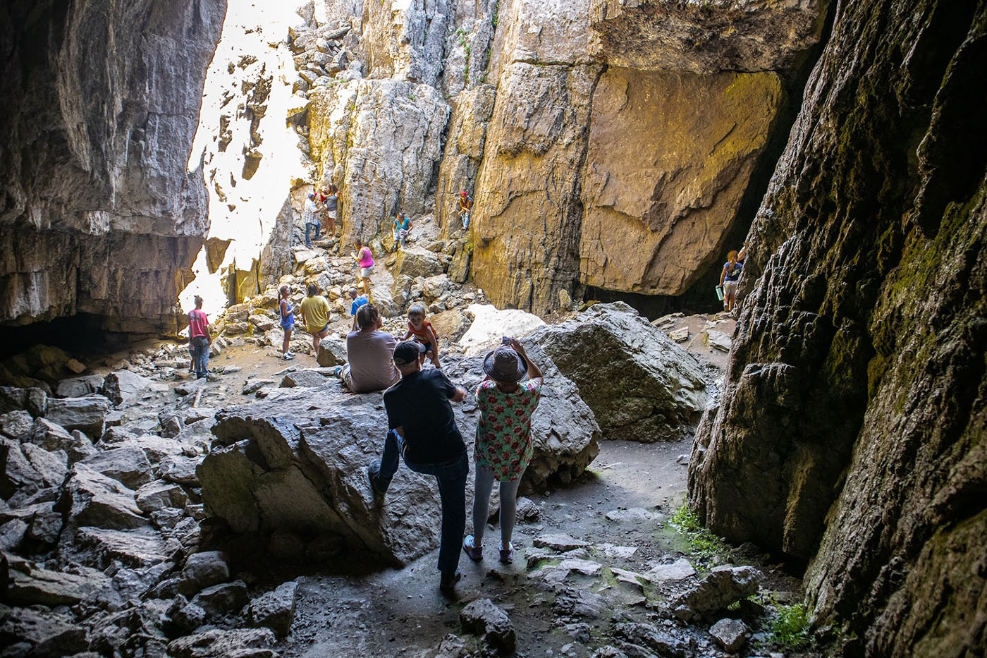 People visiting Paris Ice Cave between Paris and Preston Idaho.